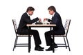 The twin brothers playing chess isolated on white Royalty Free Stock Photo