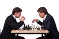 The twin brothers playing chess isolated on white Royalty Free Stock Photo