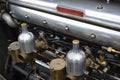 Twin carburettors on a vintage Bentley engine.