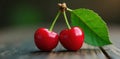 Twin cherries, vibrant red, green stem and leaf , fresh, pair, vibrant Royalty Free Stock Photo