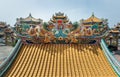 Twin Chinese dragons sculpture decorate on chinese-style temple roof Royalty Free Stock Photo