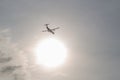 Twin-engine airliner ATR 72 against the bright sun. Royalty Free Stock Photo