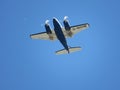 Twin engine propeller aircraft flying in clear blue sky Royalty Free Stock Photo