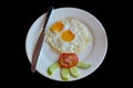 Twin fried egg served with tomato and cucumber