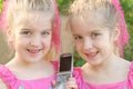 Twin girls sharing a cell phon Royalty Free Stock Photo