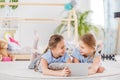 Twin girls sharing a tablet