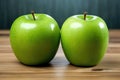 twin green apples on a wooden table