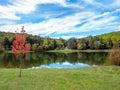 Twin Lakes nestled in the Laurel Highlands of Pennsylvania, beautiful landscape nature scene with a red tree, lake with blue skies