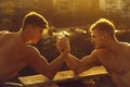 Twin men bodybuilders arm wrestling