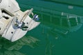 Twin outboard motors at the back of a boat. Shiny chrome propellers clear of the water`s surface