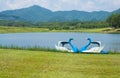 Twin Pedal boats parking near the pool in Singha park, Chiang Rai province of Thailand. Royalty Free Stock Photo