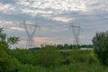 Twin Power Line Towers During Sunset Royalty Free Stock Photo