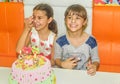 Twin sisters at birthday celebration with cake Royalty Free Stock Photo