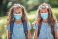 The twin sisters with face masks go back to school during the Covid-19 quarantine