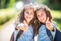 Twin sisters go back to school and showing thumbs up