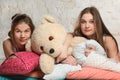 Twin sisters with pillows in the bedroom