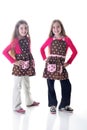 Twin sisters in polka dot aprons Royalty Free Stock Photo