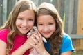 Twin sisters and puppy pet dog chihuahua playing Royalty Free Stock Photo