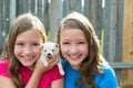 Twin sisters and puppy pet dog chihuahua playing