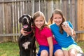 Twin sisters puppy pet dog and great dane playing Royalty Free Stock Photo