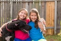 Twin sisters puppy pet dog and great dane playing Royalty Free Stock Photo