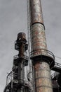 Twin smokestacks with rust patina, riveted metal, industrial site Royalty Free Stock Photo