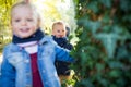 Twin toddler sibling boy and girl with parents on a walk in autumn forest. Royalty Free Stock Photo