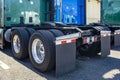 Twin wheels axles of big rigs semi trucks tractors with large tread pattern on tires for better grip