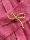 Twine bow on pink cashmere