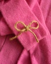 Twine bow on vivid pink cashmere robe.