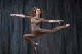 Twine in a jump. Young woman gymnast, fitness and stretching trainer shows sport exercises