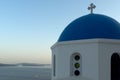 Twinlight view of Church with blue roof in town of Oia and panorama to Santorini island, Thira, Greece