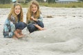 Twins with alligator sand castle