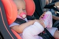 Twins boy and girl in child seats in the car. Safety transportation for babies. Children up to a year.