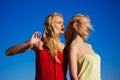 Twins girls in summer on blue sky background. Sexy woman. Beauty and fashion, look. Women with blonde hair outdoor. Royalty Free Stock Photo