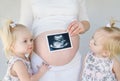 Twins Looking at New Baby Royalty Free Stock Photo