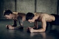 Twins muscular men working out with dumbbell. tattooed arm Royalty Free Stock Photo