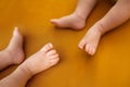 Twins newborns, brother and sister, multiple pregnancy. Baby feet. Orange colour. Copy space Royalty Free Stock Photo