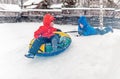 Twins play snowfall time with the inflatable sledge