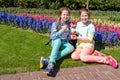 Twins share a cup of ice cream with cream and lots of fresh strawberries in spring. Siblings in Keukenhof Park, Lisse, Netherlands Royalty Free Stock Photo