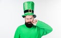 He twirling his moustache around his finger. Irish man with beard wearing green. Happy saint patricks day. Hipster in