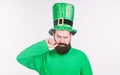 He twirling his moustache around his finger. Irish man with beard wearing green. Happy saint patricks day. Hipster in