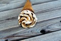 Twirling ice cream vanilla cone with topping of chocolate and caramel sauce in a crispy wafer cone , selective focus of Royalty Free Stock Photo