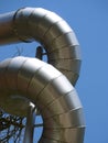 Twisted aluminium construction pipes against blue sky Royalty Free Stock Photo