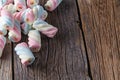 Twisted colored marshmallow on wooden table