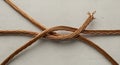 Twisted copper wires overlap on a gray surface Royalty Free Stock Photo