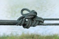 Twisted green cord on blurred background