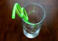 Twisted green straw in clear glass