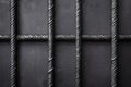 Close-up of intertwined metal bars forming grid on dark background Royalty Free Stock Photo