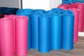 Twisted multicolored sports mats in the corner of the gym